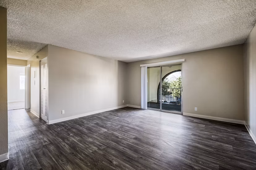 Spacious living room with modern decor and natural light in Calero Apartments