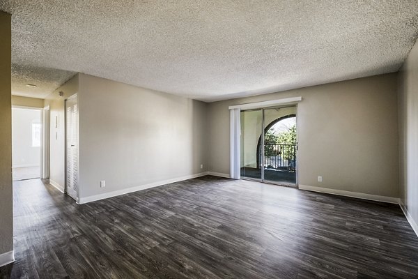 Spacious living room with modern decor and natural light in Calero Apartments