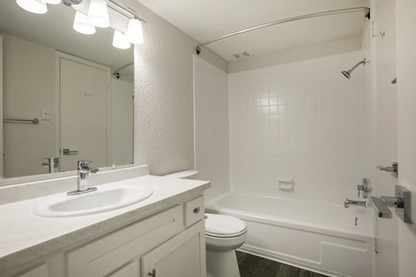 Modern bathroom featuring stylish fixtures and elegant tile design at Milo Apartments