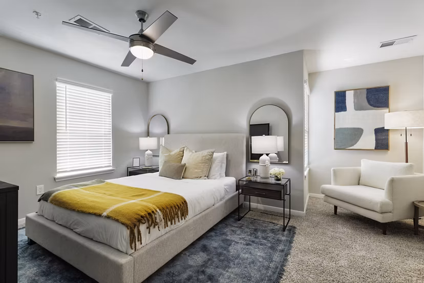Cozy bedroom with modern decor at Oltera in SoEast Apartments, luxury living by Greystar