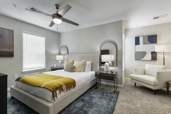 Cozy bedroom with modern decor at Oltera in SoEast Apartments, luxury living by Greystar