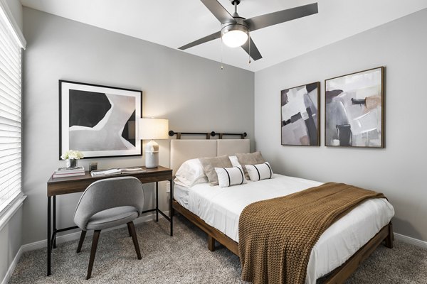 Cozy bedroom with modern decor at Oltera in SouthEast Apartments, offering comfort and luxury living