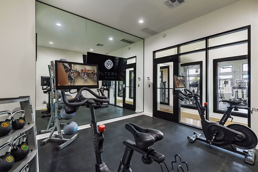 Modern fitness center with state-of-the-art equipment at Oltera in SoEast Apartments, promoting a healthy lifestyle for residents