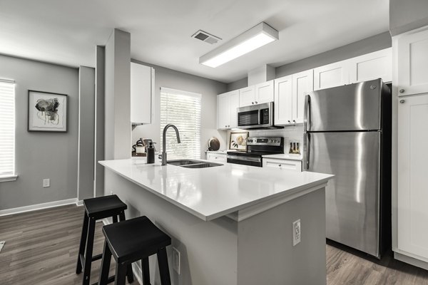 Modern kitchen with stainless steel appliances at Oltera in SoEast Apartments