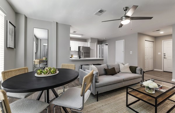 Dining area with modern furnishings and large windows at Oltera in SoEast Apartments