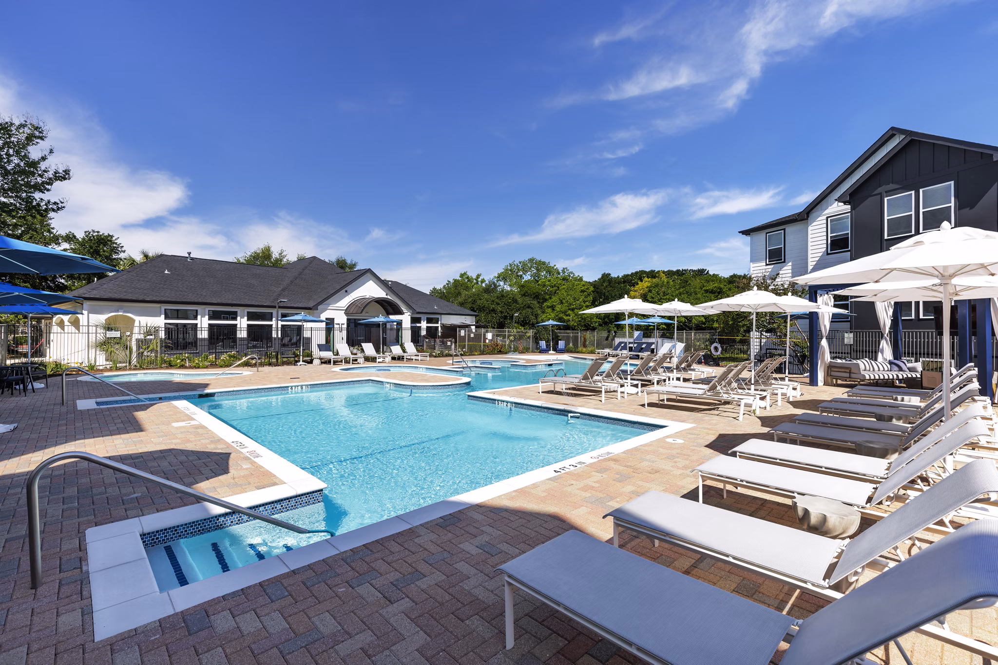 Relax by the expansive pool at Oltera in SoEast Apartments, offering luxury amenities and a serene setting