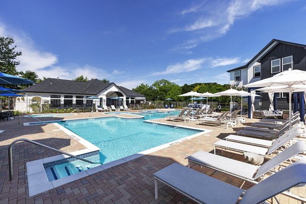 Relax by the expansive pool at Oltera in SoEast Apartments, offering luxury amenities and a serene setting