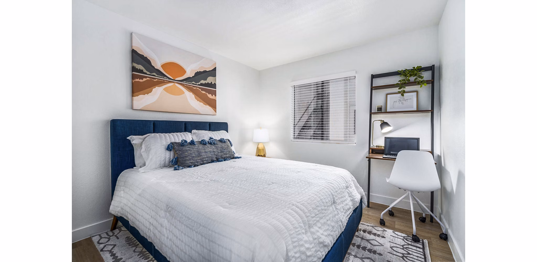 Well-lit bedroom with modern decor at Desert Shadows Apartments, featuring cozy furnishings and ample space for relaxation