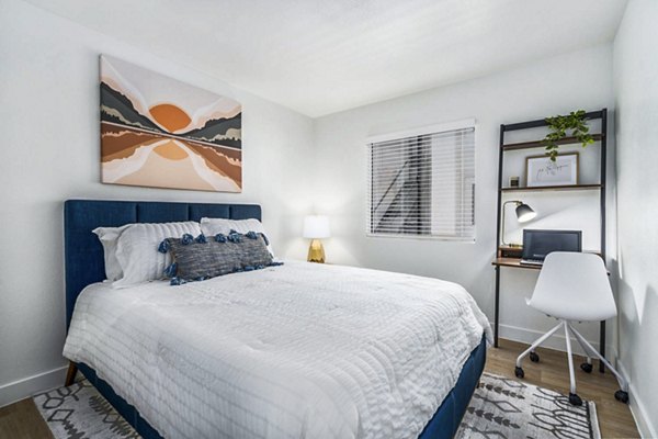 Well-lit bedroom with modern decor at Desert Shadows Apartments, featuring cozy furnishings and ample space for relaxation