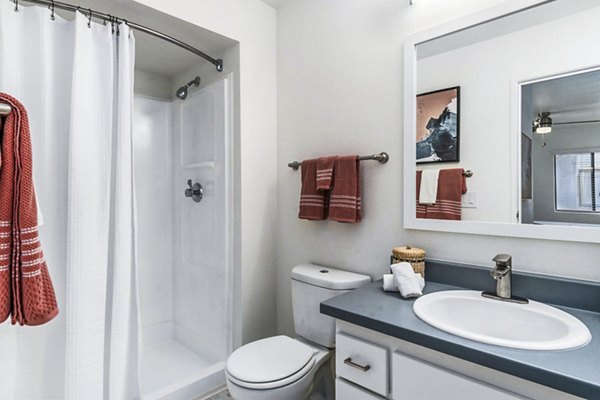 Bathroom at Desert Shadows Apartments featuring sleek fixtures and granite countertops, offering luxury living in a Greystar-managed community