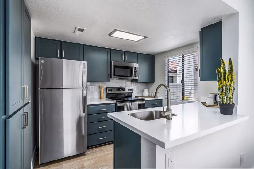 Kitchen featuring modern appliances at Desert Shadows Apartments