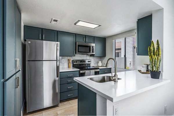 Kitchen featuring modern appliances at Desert Shadows Apartments