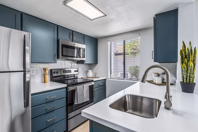 Modern kitchen with stainless steel appliances at Desert Shadows Apartments