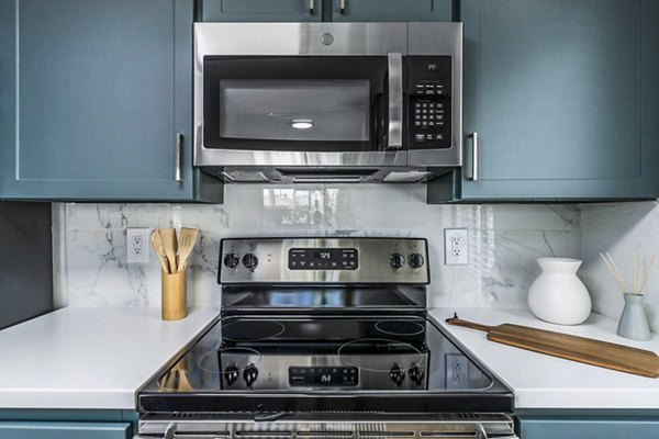 Modern kitchen with sleek countertops and stainless steel appliances at Desert Shadows Apartments