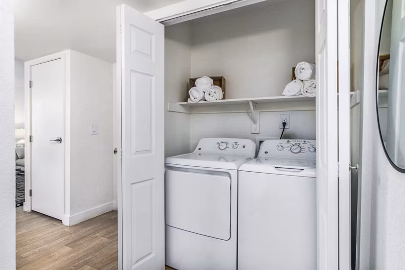 Laundry room with modern appliances at Desert Shadows Apartments, offering convenience and comfort in a luxury living environment