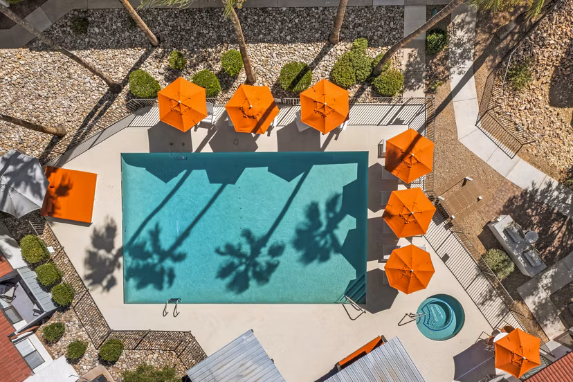 Stunning outdoor pool area with lounge chairs at Sparro Apartments, perfect for relaxation and leisure activities