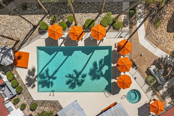 Stunning outdoor pool area with lounge chairs at Sparro Apartments, perfect for relaxation and leisure activities