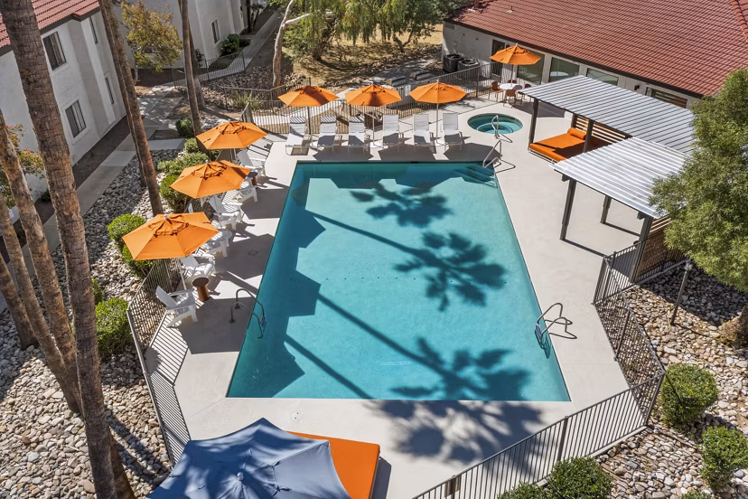 Modern outdoor pool with loungers at Sparro Apartments