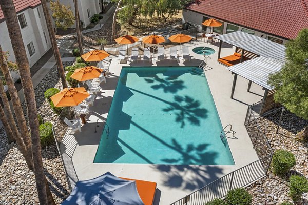 Modern outdoor pool with loungers at Sparro Apartments