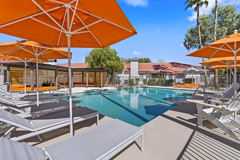 Serene outdoor pool area at Sparro Apartments, featuring modern design and lush landscaping