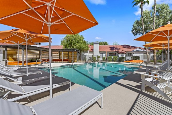 Serene outdoor pool area at Sparro Apartments, featuring modern design and lush landscaping