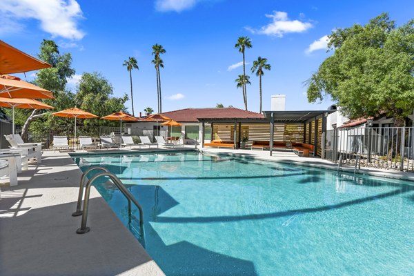 Relaxing outdoor pool area at Sparro Apartments, perfect for lounging and swimming in a vibrant community setting