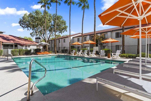 Sparkling outdoor pool at Sparro Apartments with sun loungers and landscaped surroundings, perfect for relaxation and leisure