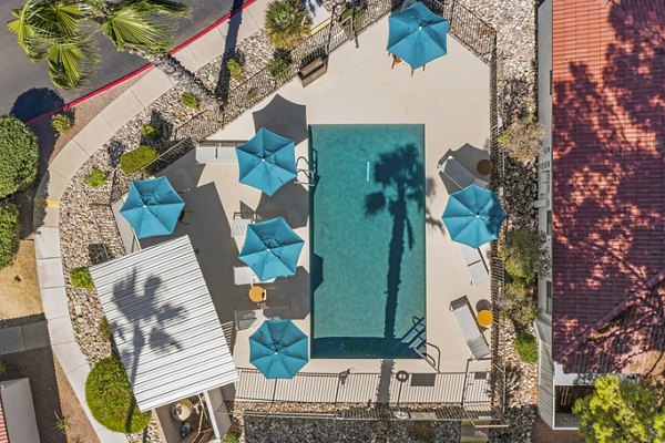 Sparro Apartments: Luxurious pool with lounge chairs and shaded cabanas, perfect for relaxation in our premium community