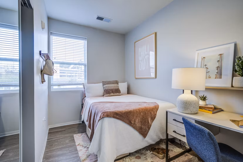 Cozy bedroom with neutral tones and modern furnishings in Union Tuscaloosa Apartments