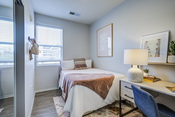 Cozy bedroom with neutral tones and modern furnishings in Union Tuscaloosa Apartments