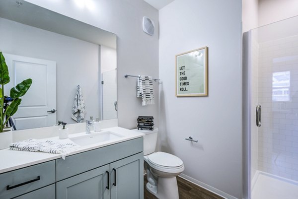 Modern bathroom featuring granite countertops and sleek fixtures at Union Tuscaloosa Apartments, offering luxury living spaces