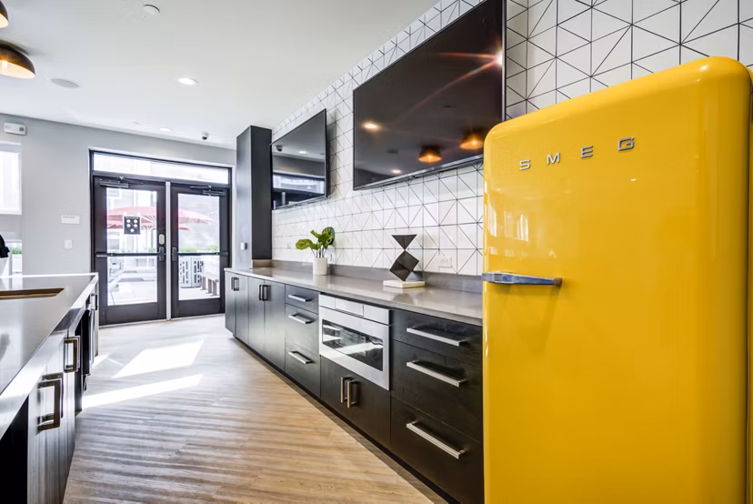 Modern clubhouse kitchen with sleek countertops and stainless steel appliances at Union Tuscaloosa Apartments