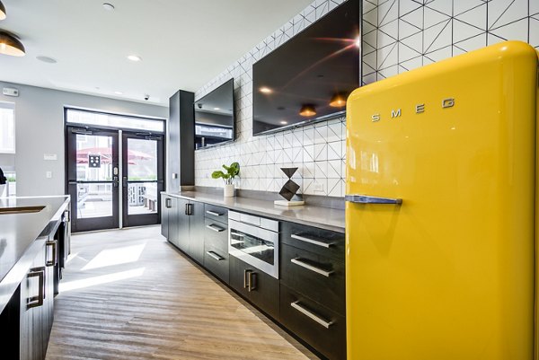 Modern clubhouse kitchen with sleek countertops and stainless steel appliances at Union Tuscaloosa Apartments