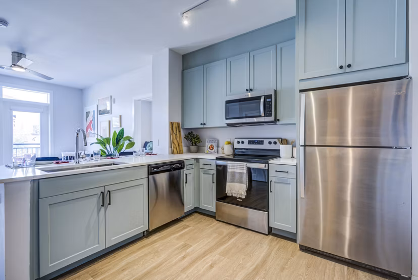Modern kitchen with stainless steel appliances at Union Tuscaloosa Apartments, offering luxury living by Greystar