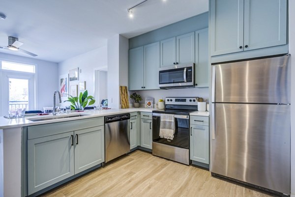 Modern kitchen with stainless steel appliances at Union Tuscaloosa Apartments, offering luxury living by Greystar