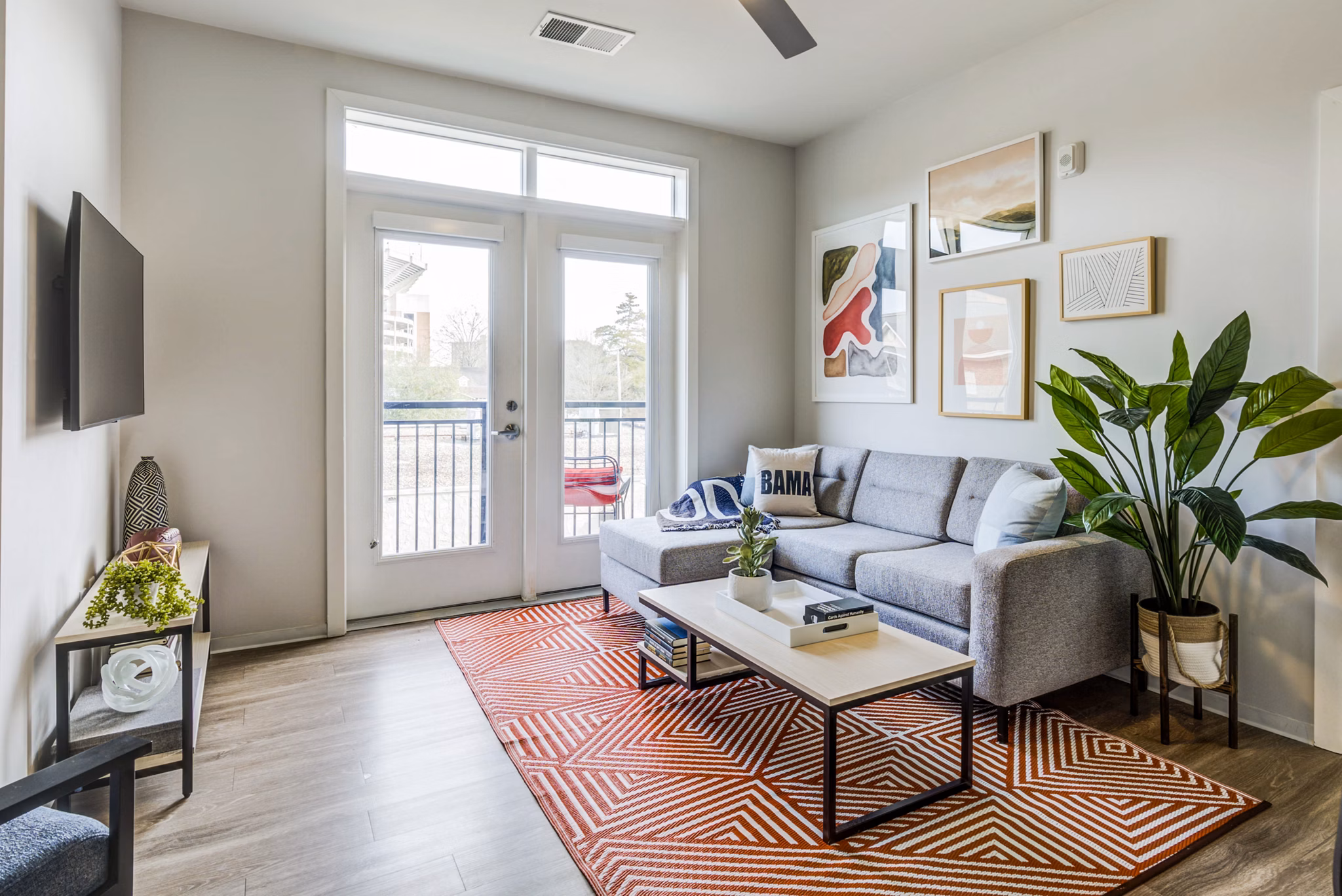 Spacious living room with modern decor at Union Tuscaloosa Apartments, a luxury Greystar community