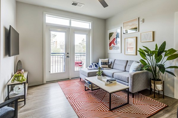 Spacious living room with modern decor at Union Tuscaloosa Apartments, a luxury Greystar community