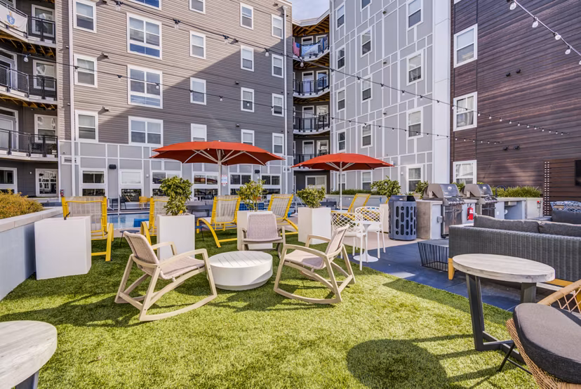 Grill area next to pool at Union Tuscaloosa Apartments, perfect for outdoor dining and relaxation