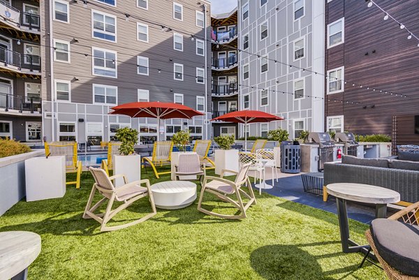 Grill area next to pool at Union Tuscaloosa Apartments, perfect for outdoor dining and relaxation