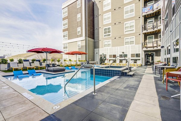 Inviting outdoor pool area with sundeck at Union Tuscaloosa Apartments, perfect for relaxation and recreation
