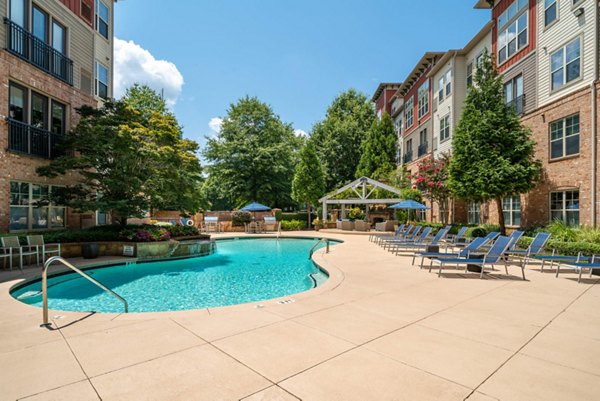 Outdoor swimming pool surrounded by lush landscaping at Westmount Ashwood Apartments, luxury living in a serene community setting