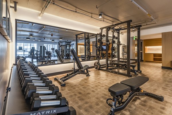 Well-equipped fitness center with modern machines at Arista Apartments, featuring cardio and strength training equipment for active lifestyles