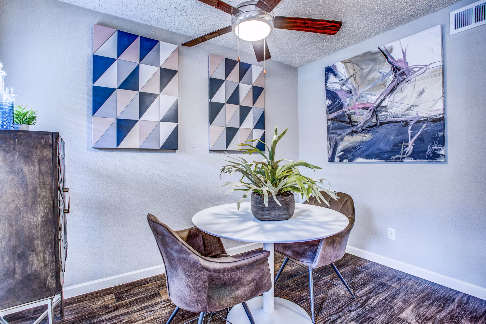 Dining room featuring elegant dining set and modern lighting fixtures at The Oakley Apartments, a Greystar luxury apartment community