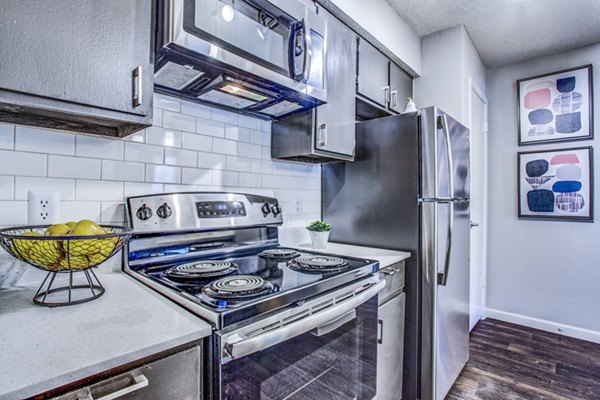 Spacious kitchen with granite countertops and stainless appliances at The Oakley Apartments