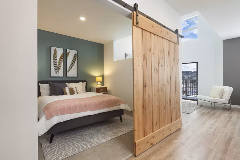 Cozy bedroom with chic decor at Spencer 68 Apartments, offering modern amenities and a comfortable living space