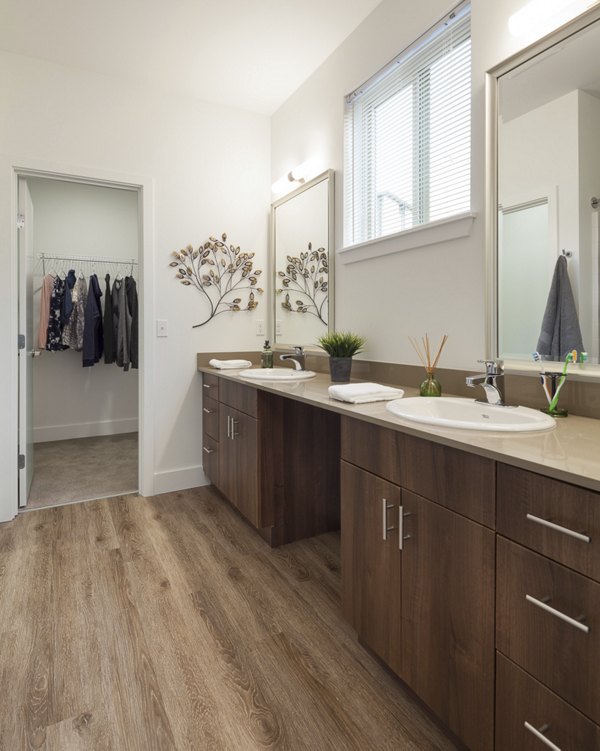 Modern bathroom with elegant fixtures in Spencer 68 Apartments, showcasing luxury living amenities in a stylish, contemporary setting