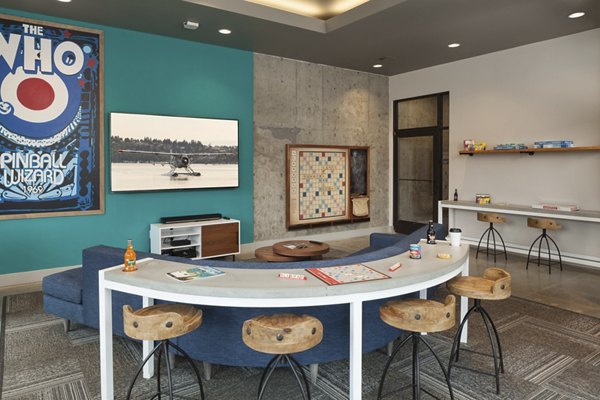 Game room featuring pool table and modern seating at Spencer 68 Apartments
