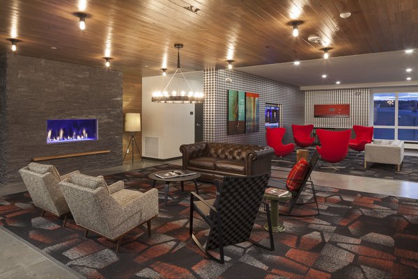 Elegant clubhouse at Spencer 68 Apartments with cozy seating areas and modern decor, perfect for social gatherings and events