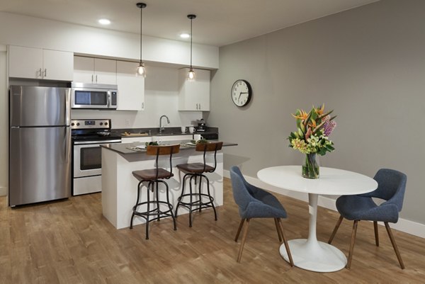 Dining area with modern decor and elegant lighting at Spencer 68 Apartments