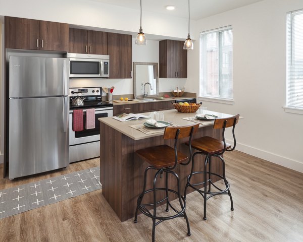 Modern kitchen with stainless steel appliances at Spencer 68 Apartments, luxury apartment living